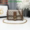 Brown handbag with monogram pattern, gold chain strap, and logo, size 20x14x7 cm, beside decor.