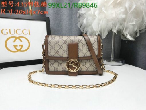 Brown handbag with monogram pattern, gold chain strap, and logo, size 20x14x7 cm, beside decor.